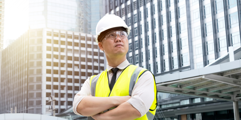 construction project management. Foreman looking at the building